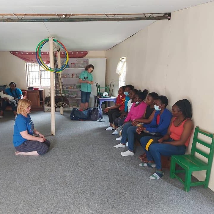 A therapist leading a group session with children